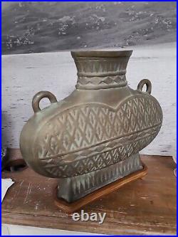 Large bronze archaic style vase with hatched pattern and loop handles, open base